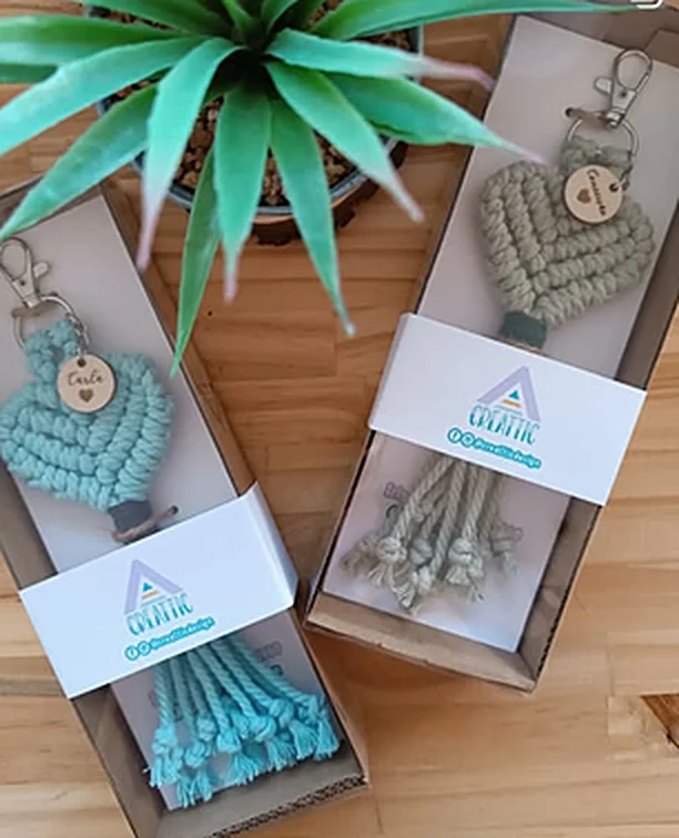 Two macramé keychains in kraft boxes with a Creattic sleeve.